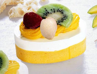 Mouth watering Mango dairy ice cream combined with mango fruit sauce topped with pieces of Mango.